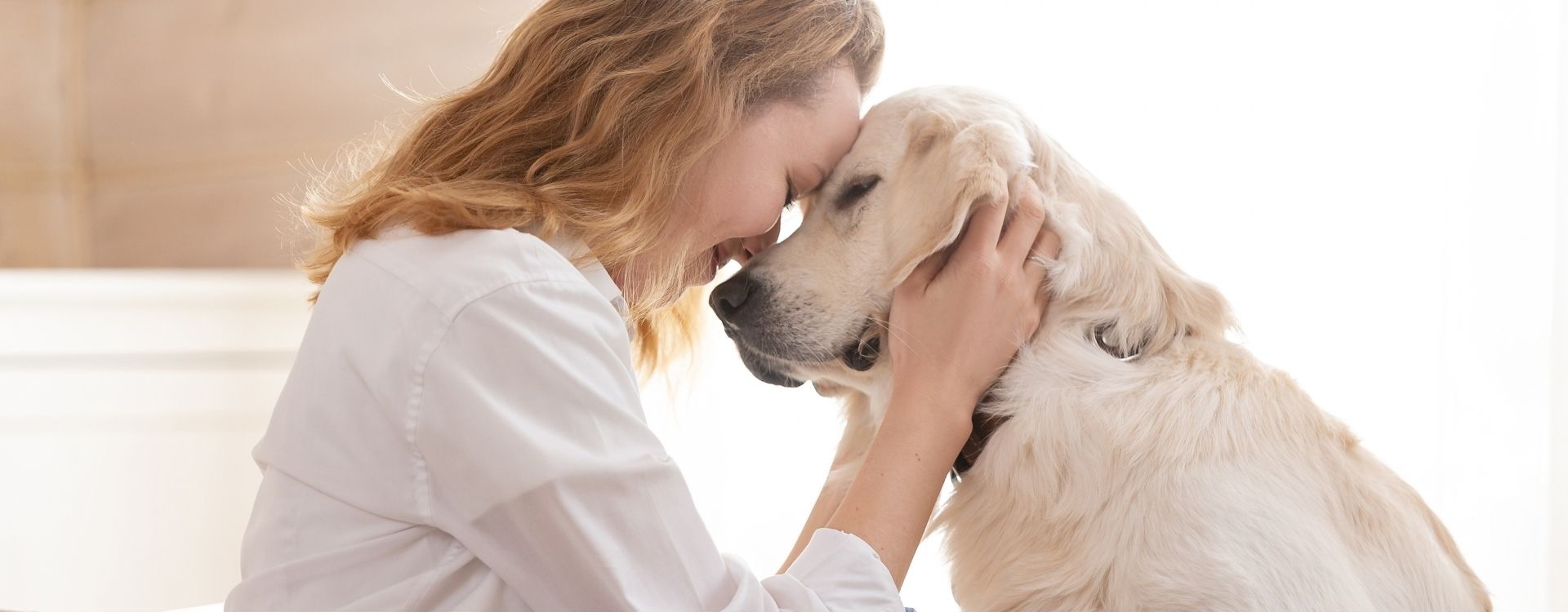 woman face to face with a dog